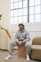 'REINVENT' HOODIE IN STONE