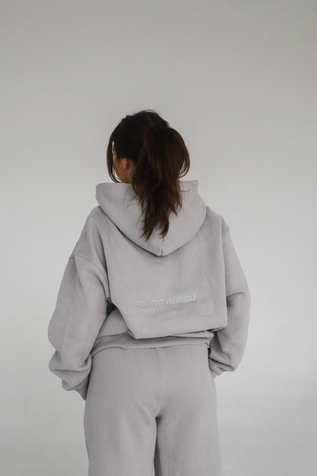 'REINVENT' HOODIE IN STONE