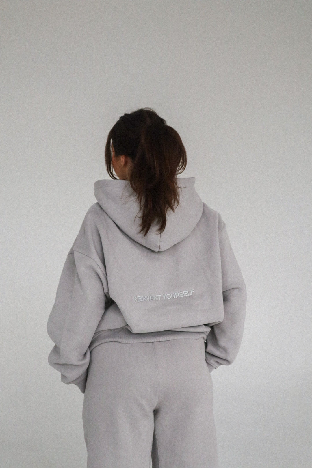'REINVENT' HOODIE IN STONE